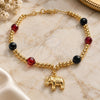 Pulsera de Dije 03.32.0228.07 Oro Laminado, Diseño de Elefante y Bola, con Azavache Negro y Cristal Rubi, Pulido, Tono Dorado (7 Pulgadas de Largo)
