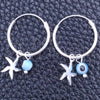 Argolla Pequeña 02.401.0037.15 Plata Rodinada, Diseño de Ojo Griego y Flor, con Cristal Aqua Azul, Pulido, Tono Plateado
